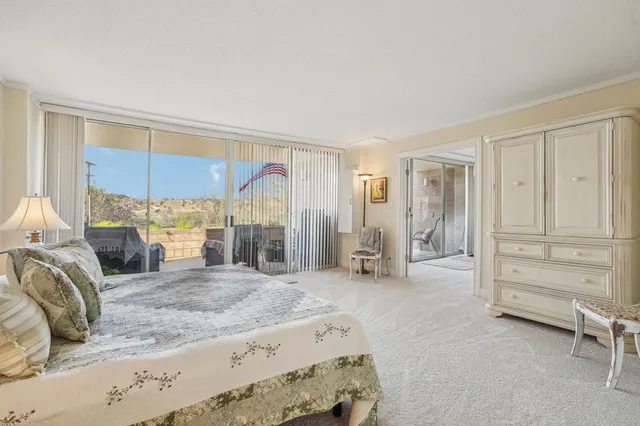 a large bedroom with a bed and large mirror