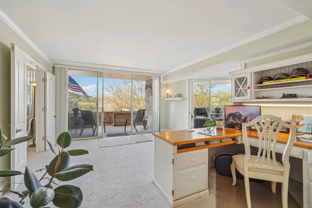 a room with furniture a flat screen tv and a large window