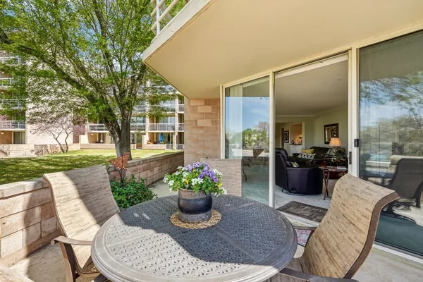 a view of a balcony with table and chairs