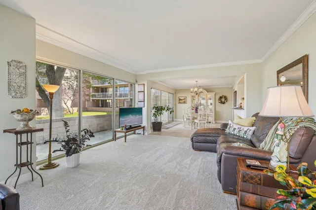 a living room with furniture a lamp and a floor to ceiling window