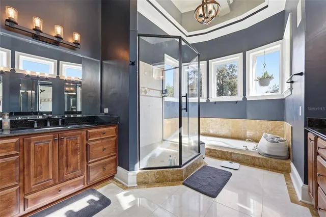 a living room with furniture fireplace and a large window