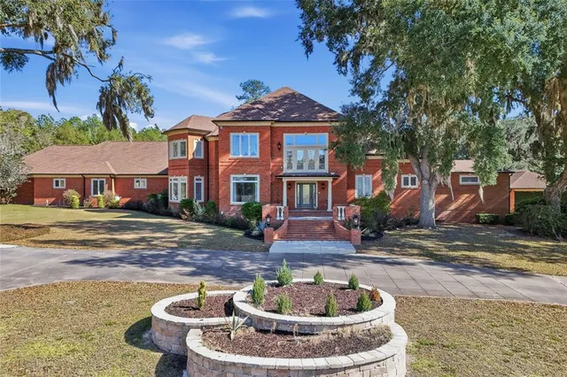 a front view of a house with a fountain