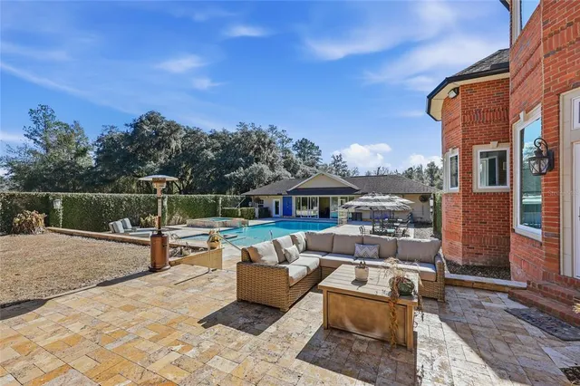 an aerial view of a house with a yard and trees