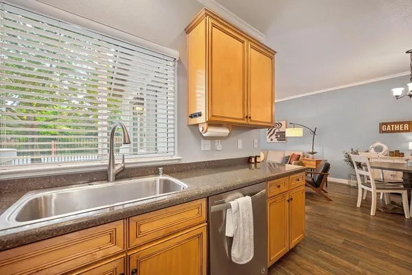 a kitchen with granite countertop a sink and a window