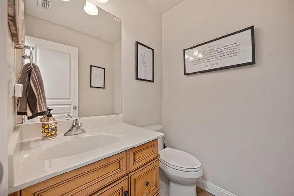 a bathroom with a sink toilet and mirror