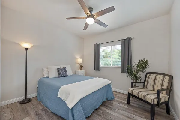 a bedroom with a large bed and a chair