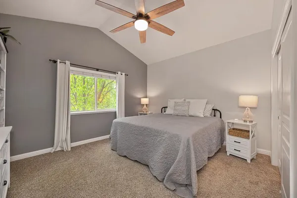 a bedroom with a bed and a window
