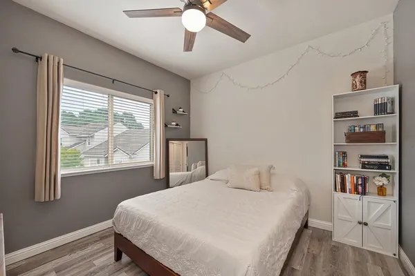 a bedroom with a bed and a potted plant