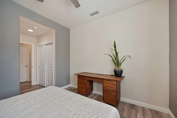 a bathroom with a granite countertop sink mirror vanity and toilet