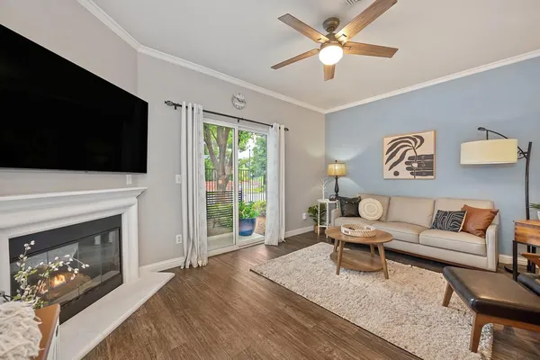 a living room with furniture a fireplace and a flat screen tv