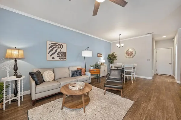 a living room with furniture and wooden floor