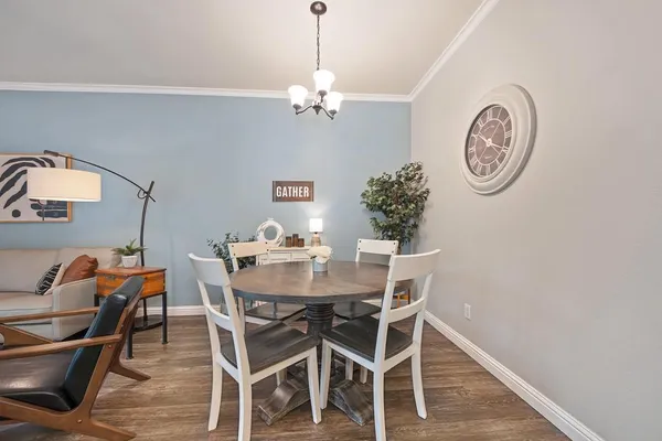 a view of a dining room with furniture and wooden floor