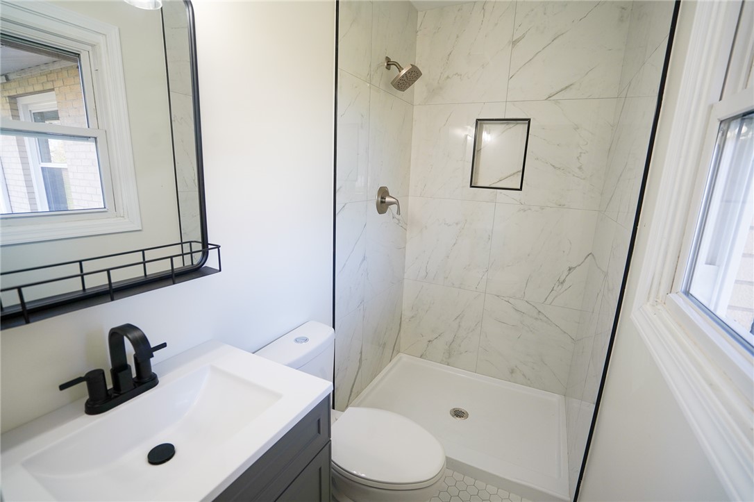 8746 Grubbs-Rex Road Arcanum, OH 45304 - Photo 6 of 38 This modern bathroom features a stylish vanity, sleek shower, and ample natural light.