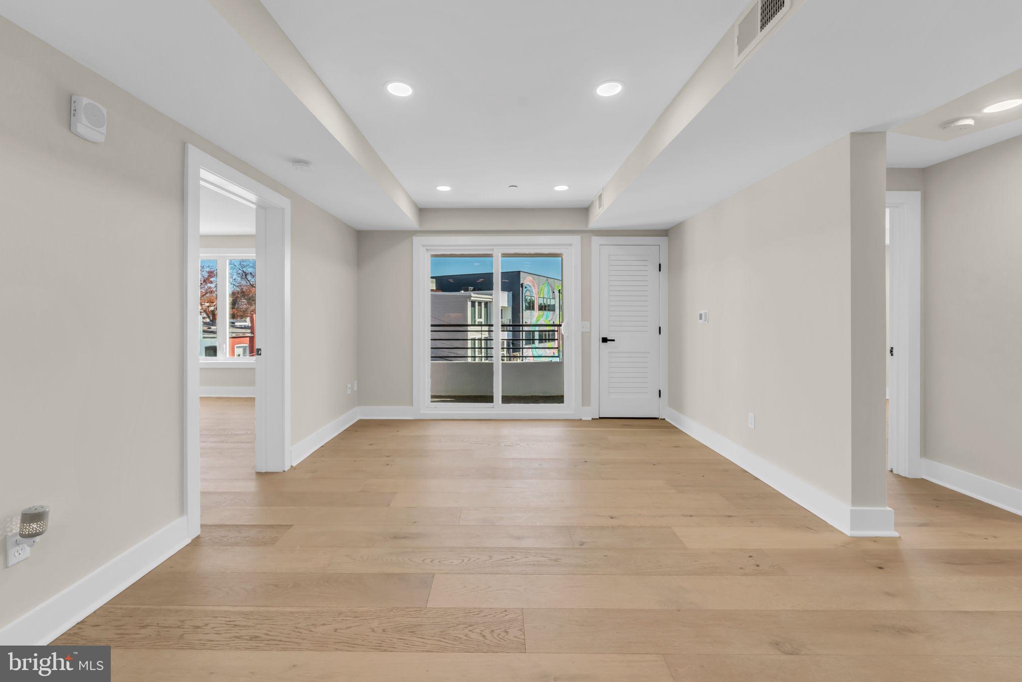 919 12th Street Northeast, Unit A303 Washington, DC 20002 - Photo 12 of 45 wooden floor in an empty room with a window