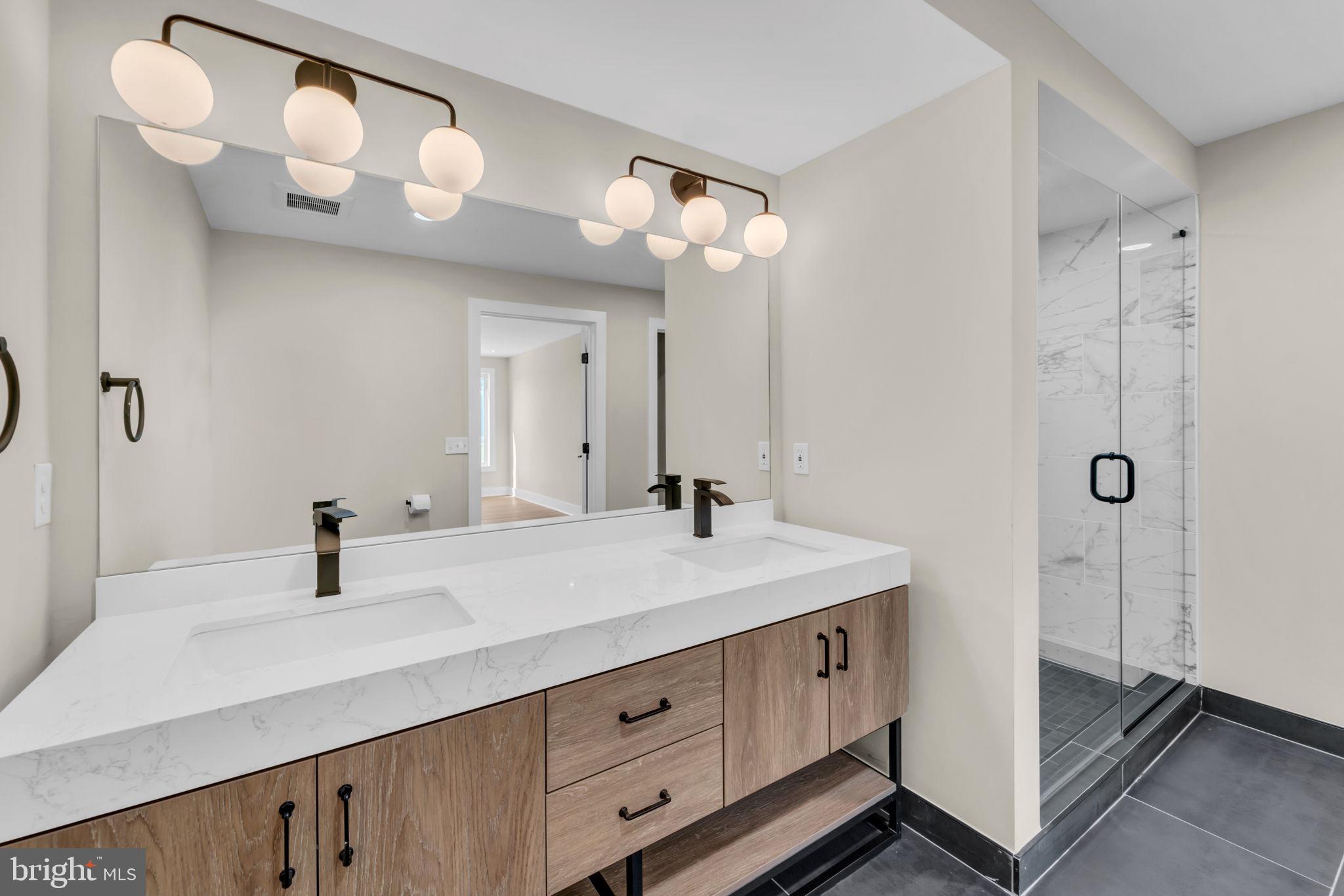 919 12th Street Northeast, Unit A303 Washington, DC 20002 - Photo 15 of 45 a bathroom with a sink a mirror and vanity