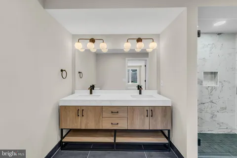 a bathroom with a double vanity sink and mirror