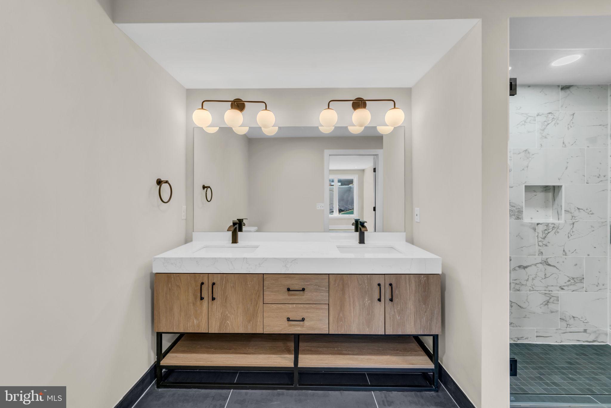 919 12th Street Northeast, Unit A303 Washington, DC 20002 - Photo 16 of 45 a bathroom with a sink and a mirror