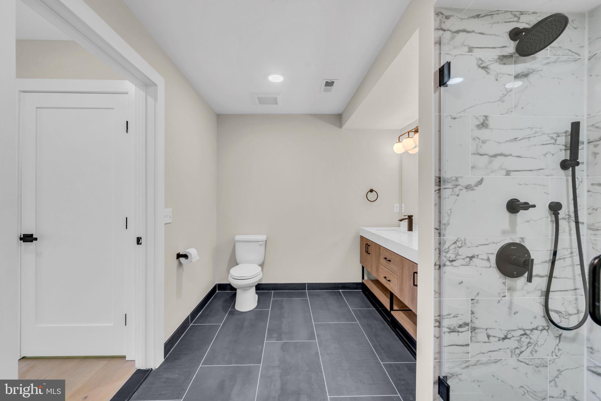 919 12th Street Northeast, Unit A303 Washington, DC 20002 - Photo 17 of 45 a bathroom with a double vanity sink and mirror