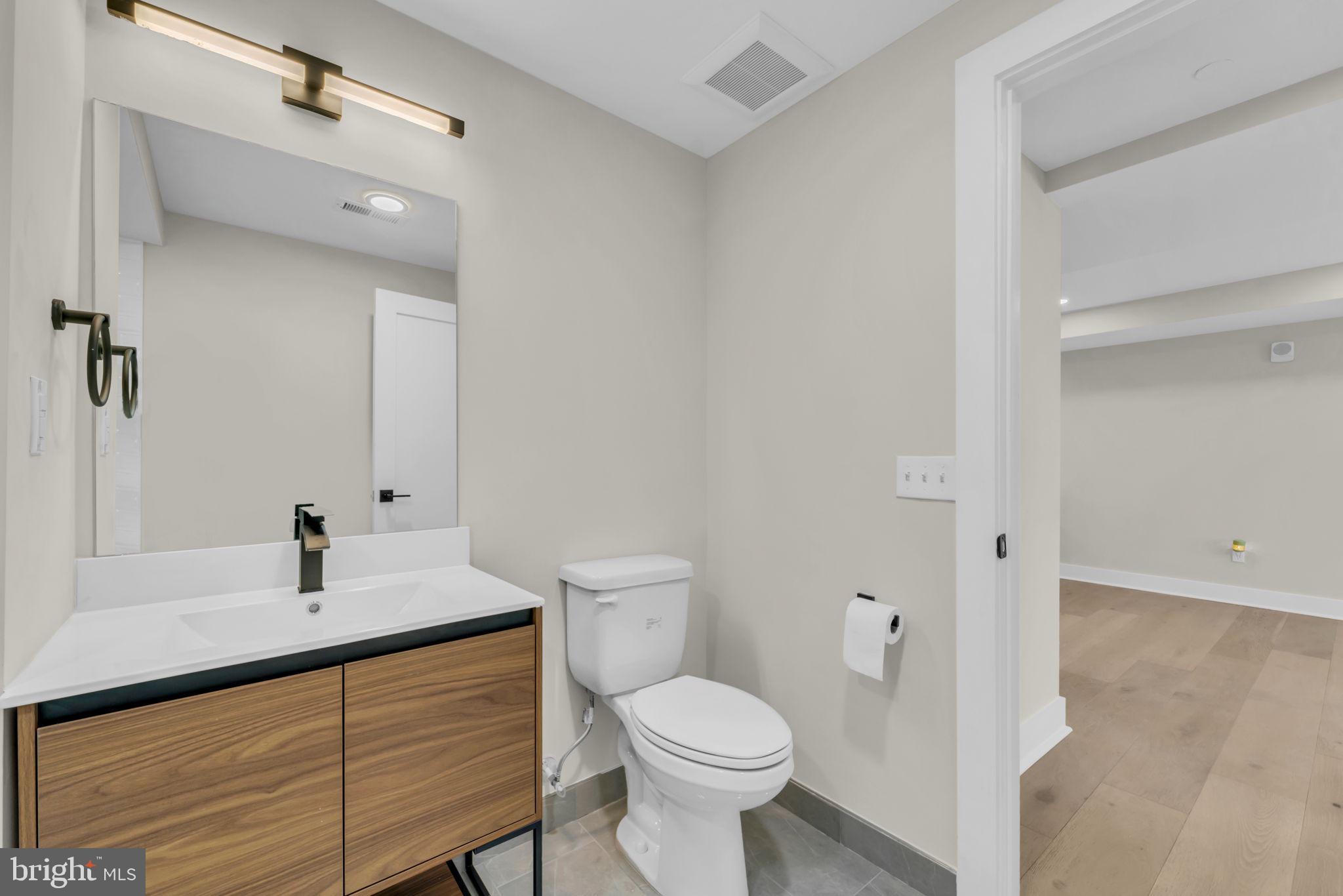919 12th Street Northeast, Unit A303 Washington, DC 20002 - Photo 25 of 45 a bathroom with a sink a toilet and shower