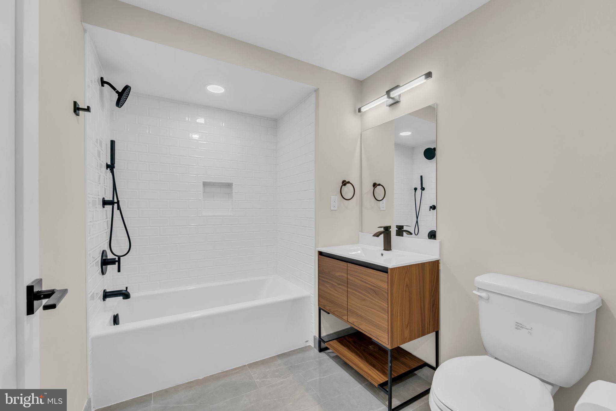 919 12th Street Northeast, Unit A303 Washington, DC 20002 - Photo 29 of 45 a bathroom with a sink toilet and shower
