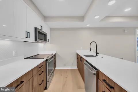 a view of a hallway with washer and dryer