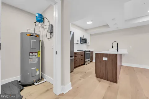 a large kitchen with kitchen island a sink a stove and refrigerator