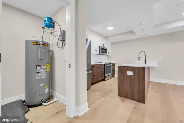 a large kitchen with kitchen island a sink a stove and refrigerator