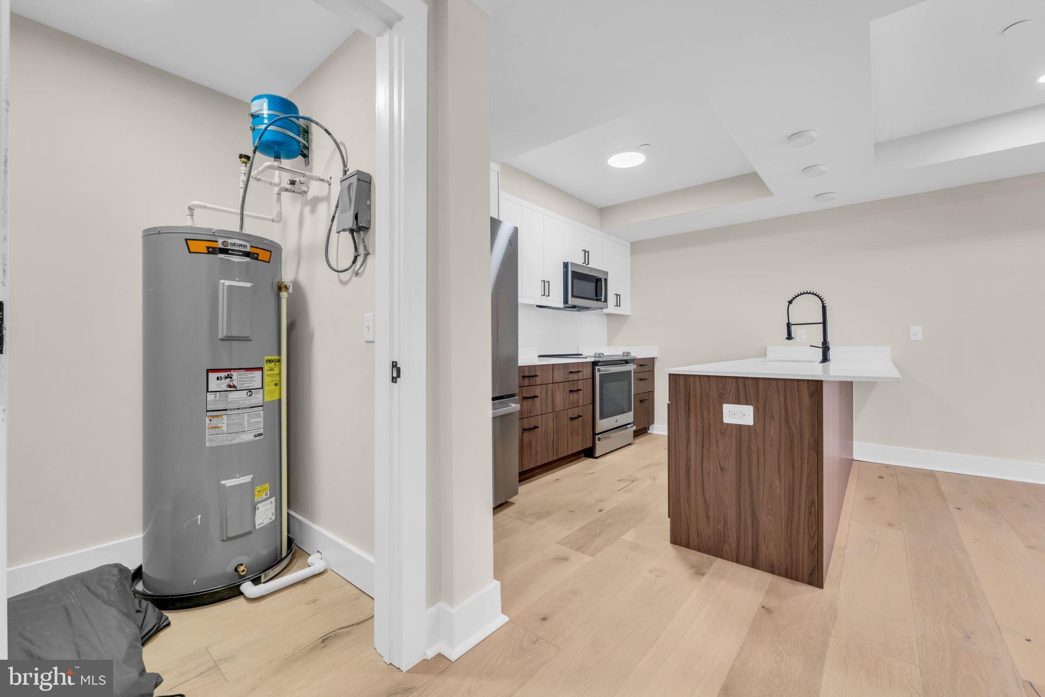 919 12th Street Northeast, Unit A303 Washington, DC 20002 - Photo 33 of 45 a view of a kitchen with fridge and wooden floor