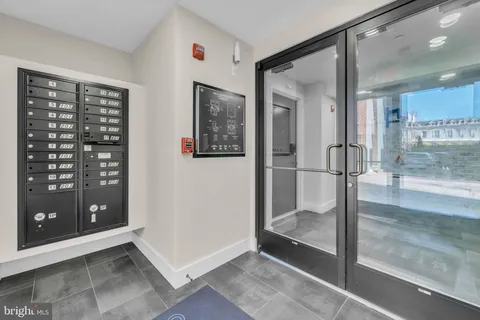 a view of a hallway with wooden shelves and entryway