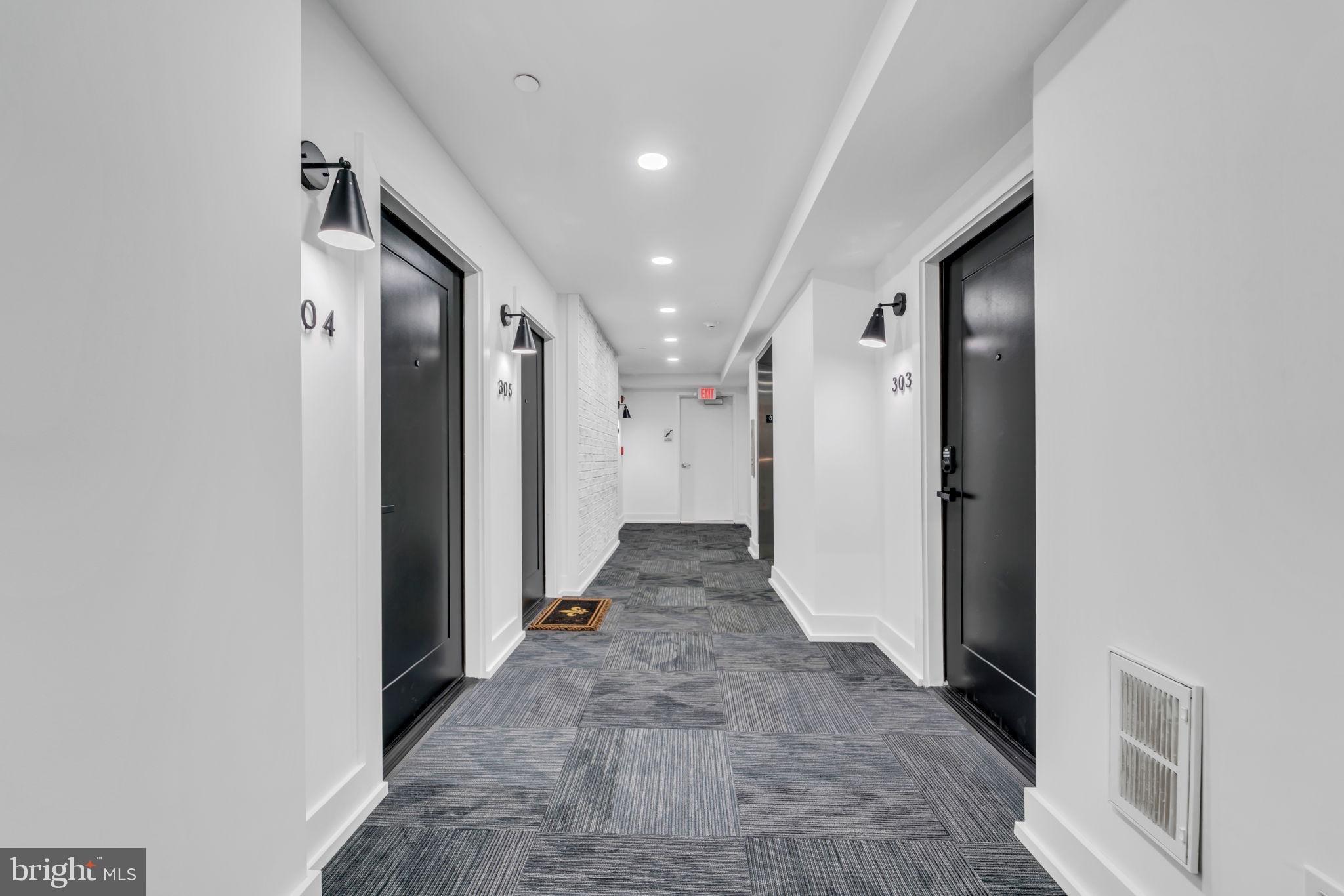 919 12th Street Northeast, Unit A303 Washington, DC 20002 - Photo 39 of 45 a view of a hallway with wooden shelves and entryway