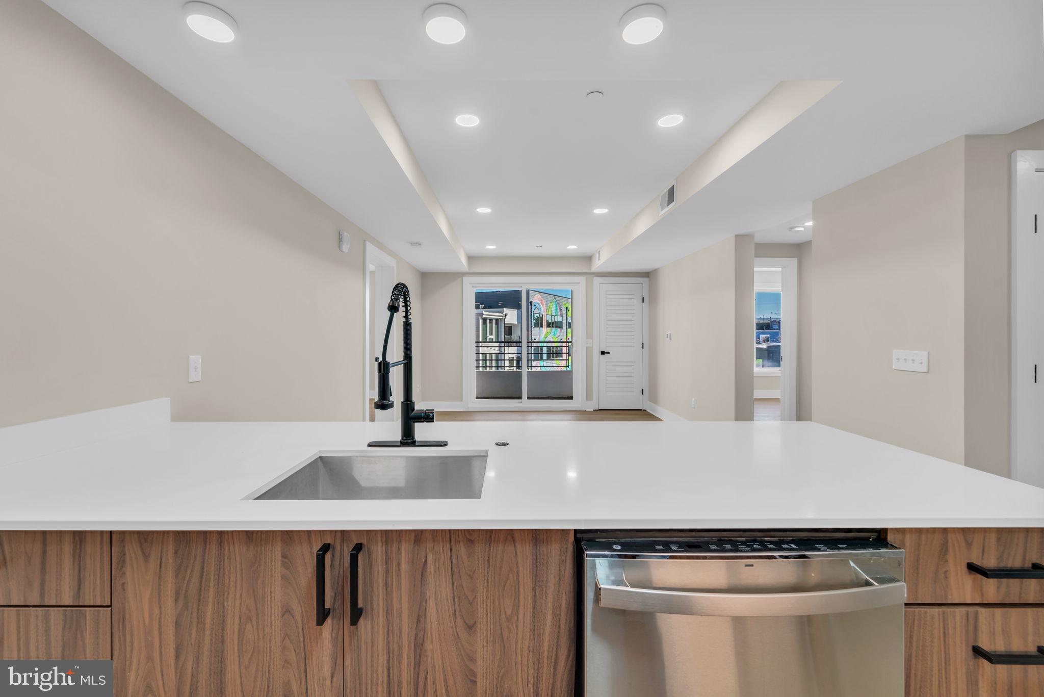 919 12th Street Northeast, Unit A303 Washington, DC 20002 - Photo 4 of 45 a kitchen with a sink and cabinets