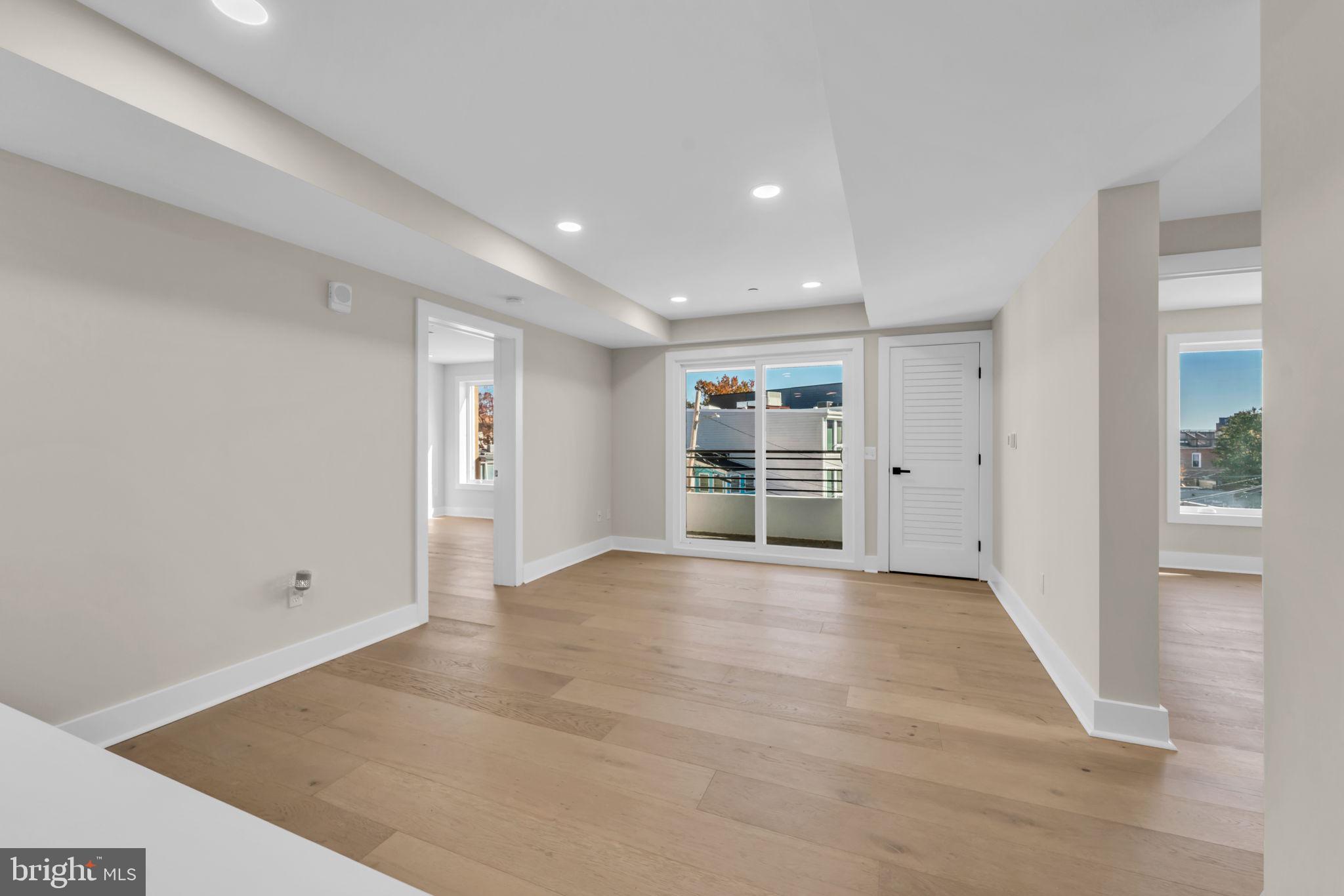 919 12th Street Northeast, Unit A303 Washington, DC 20002 - Photo 9 of 45 an empty room with wooden floor and windows