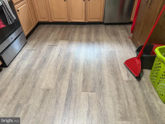 a view of wooden floor and closet in a kitchen
