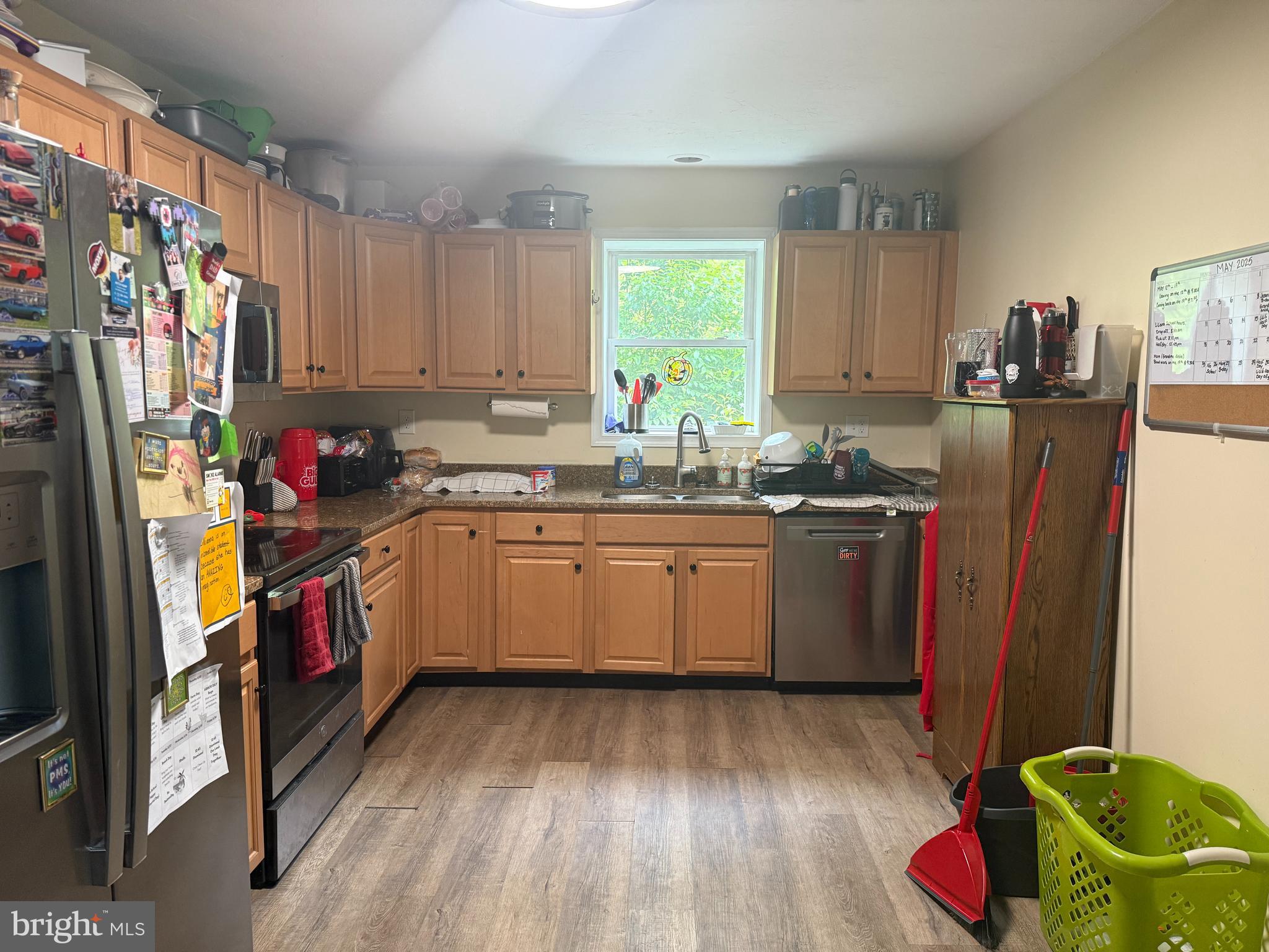 4810 Fake Road York, PA 17406 - Photo 5 of 58 a kitchen with a refrigerator wooden floor and cabinets