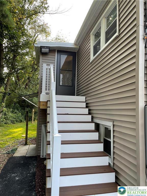 a view of a house with large windows and a small yard