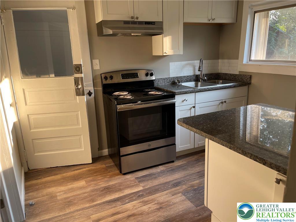5454-5460 Camp Meeting Road, Unit 2 Center Valley, PA 18034 - Photo 2 of 4 a kitchen with granite countertop a stove and a sink