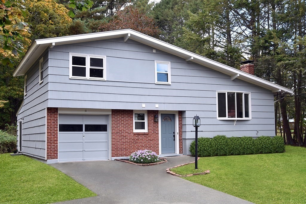 11 Sandy Avenue Canton, MA 02021 - Photo 1 of 20 a front view of a house with a yard and garage