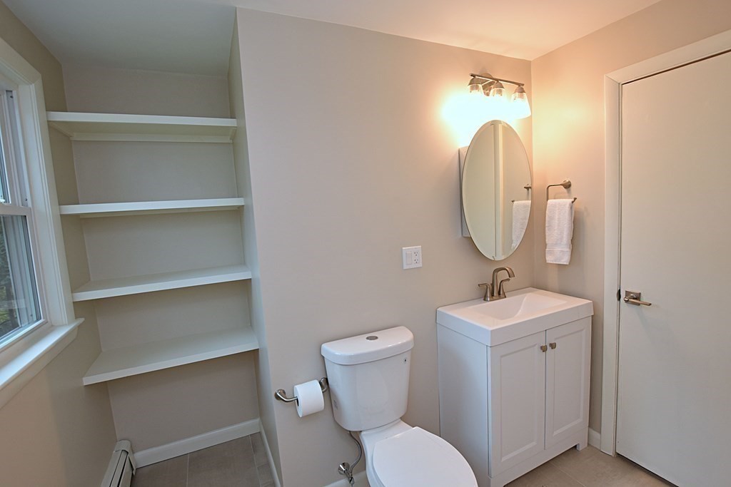11 Sandy Avenue Canton, MA 02021 - Photo 12 of 20 a bathroom with a toilet sink and mirror