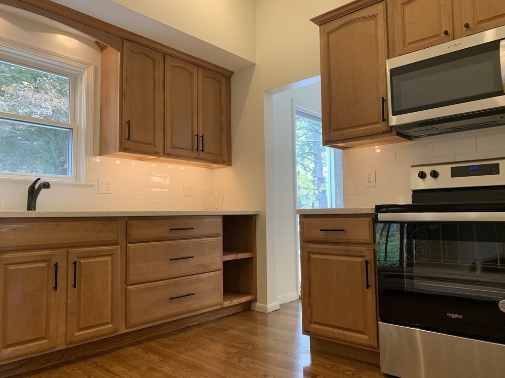 11 Sandy Avenue Canton, MA 02021 - Photo 8 of 20 a kitchen with granite countertop cabinets stainless steel appliances and wooden floor