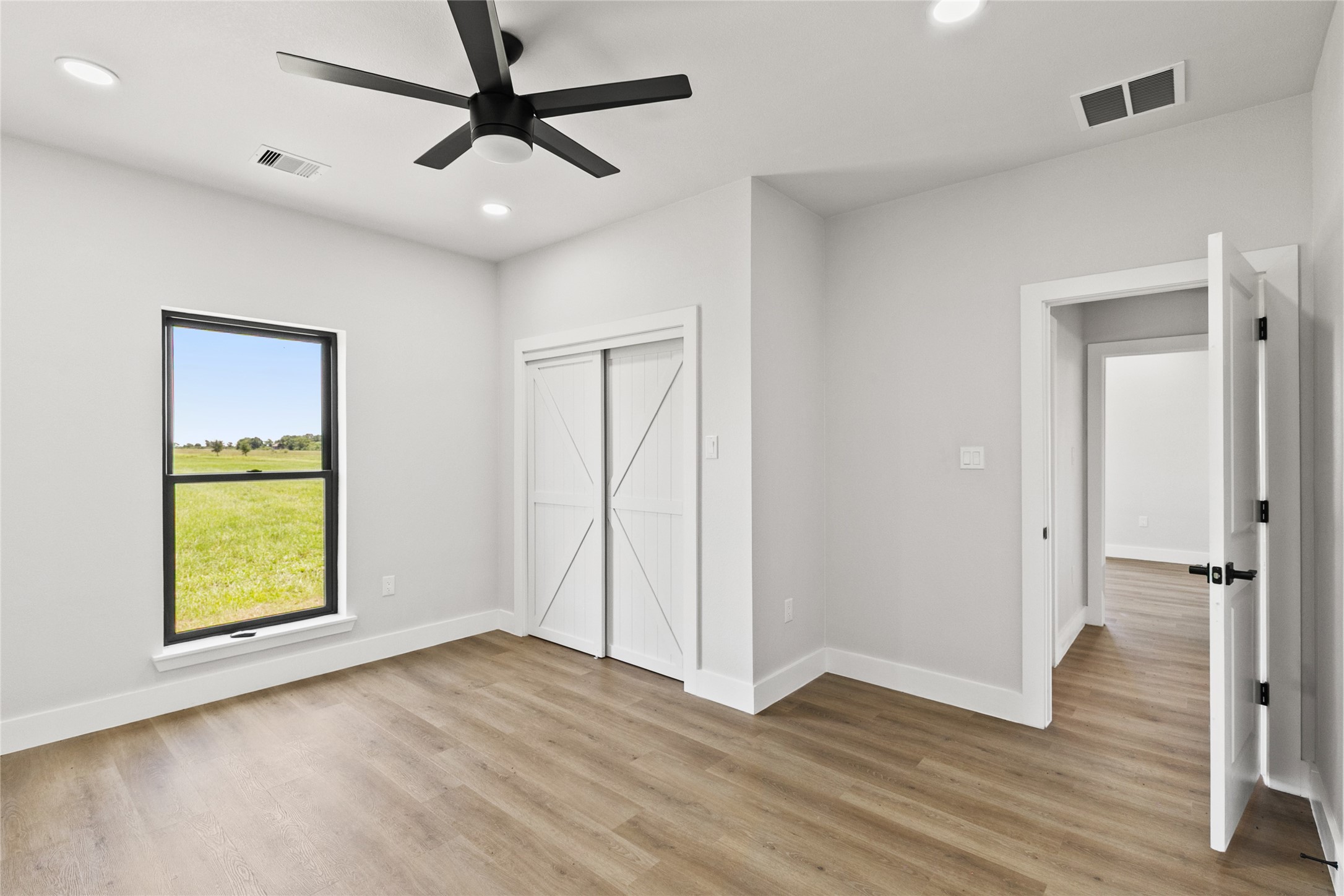 619 Chuckwagon Trail Angleton, TX 77515 - Photo 26 of 37 Secondary bedroom with a closet and convenient access to the full guest bathroom. Natural light and neutral finishes provide a comfortable space for guests, family, or a home office.