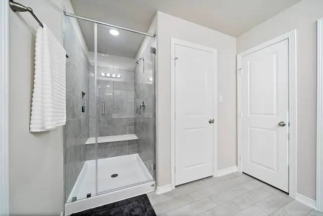 a bathroom with a glass shower door