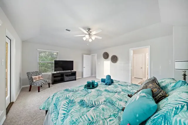 a bedroom with a bed and a flat screen tv