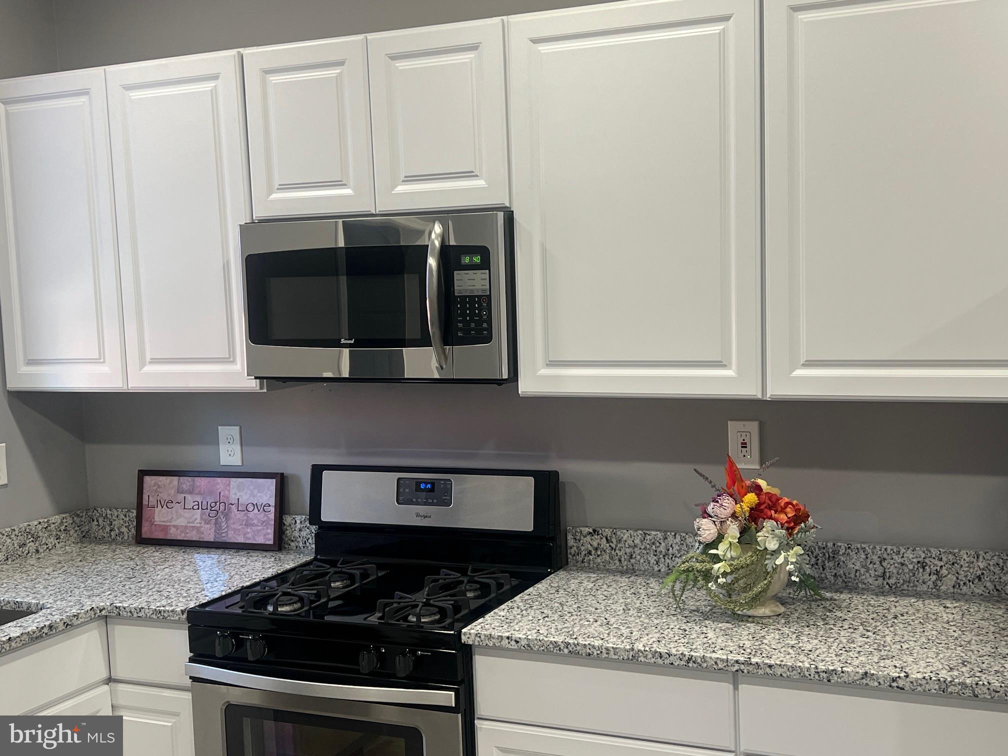 2225 Homewood Avenue Baltimore, MD 21218 - Photo 16 of 29 a kitchen with stainless steel appliances granite countertop white cabinets and a stove
