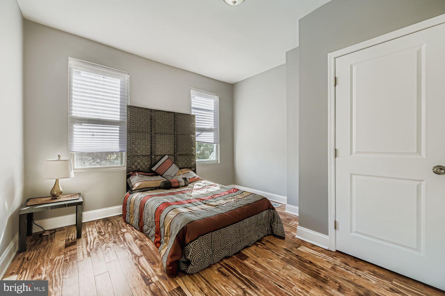2225 Homewood Avenue Baltimore, MD 21218 - Photo 19 of 29 a bedroom with a bed and wooden floor