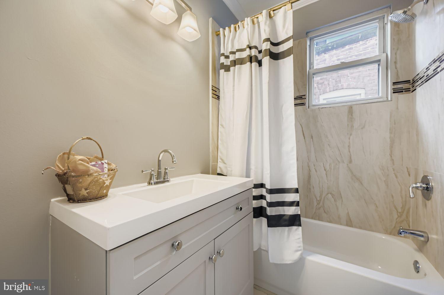 2225 Homewood Avenue Baltimore, MD 21218 - Photo 21 of 29 a bathroom with a sink and a mirror