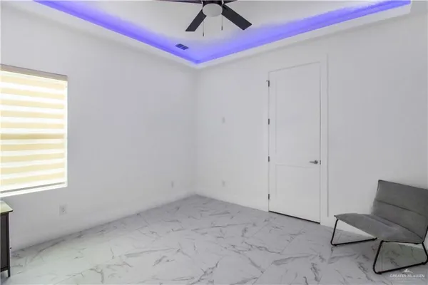 a view of room with window and ceiling fan