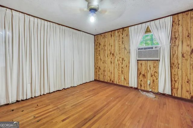 wooden floor in an empty room with a window