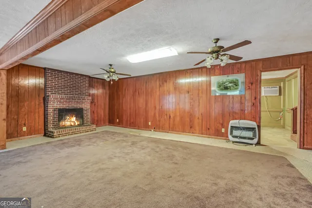 a view of an empty room with a fireplace
