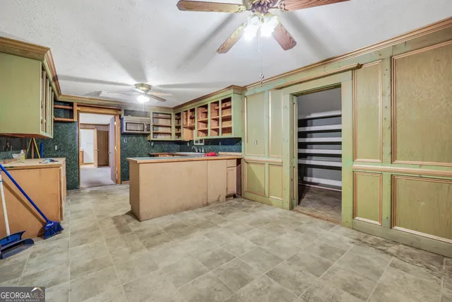 a kitchen with stainless steel appliances kitchen island granite countertop a refrigerator and a stove top oven