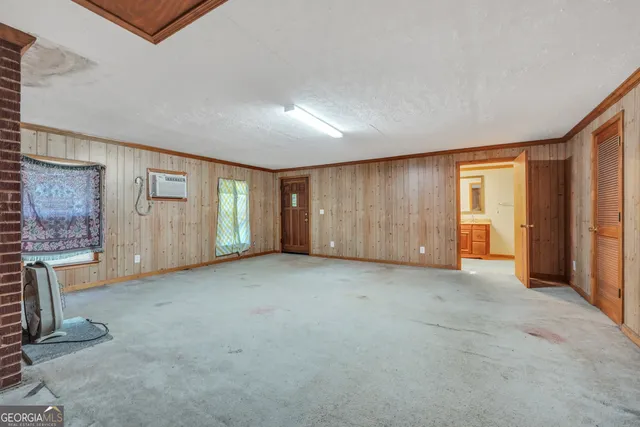 a view of an empty room with a fireplace